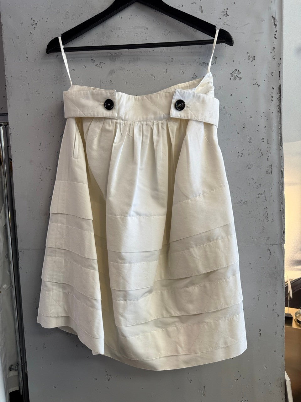 BERLIN VINTAGE CORNER Yves Saint Laurent Rive Gauche off-white pleated skirt with quilted waistband and black buttons.