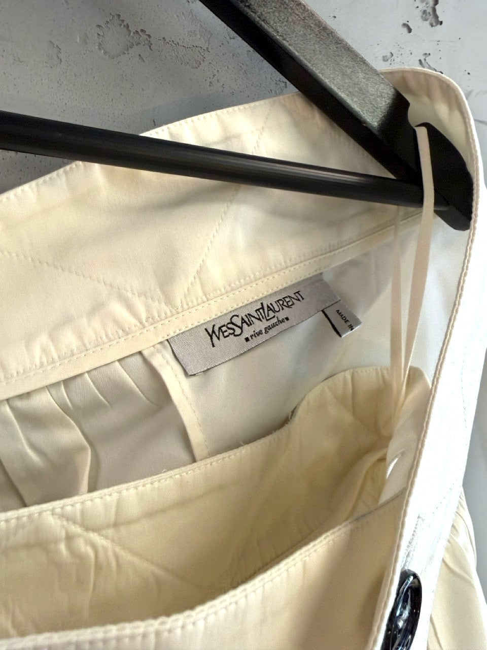 BERLIN VINTAGE CORNER Yves Saint Laurent Rive Gauche off-white pleated skirt with quilted waistband and black button details.