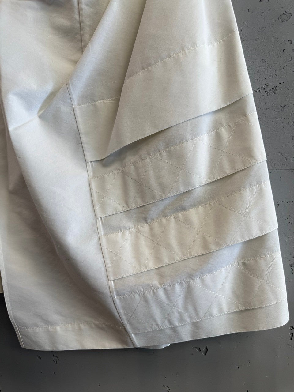 BERLIN VINTAGE CORNER off-white YSL Rive Gauche skirt with quilted waistband and black button details.
