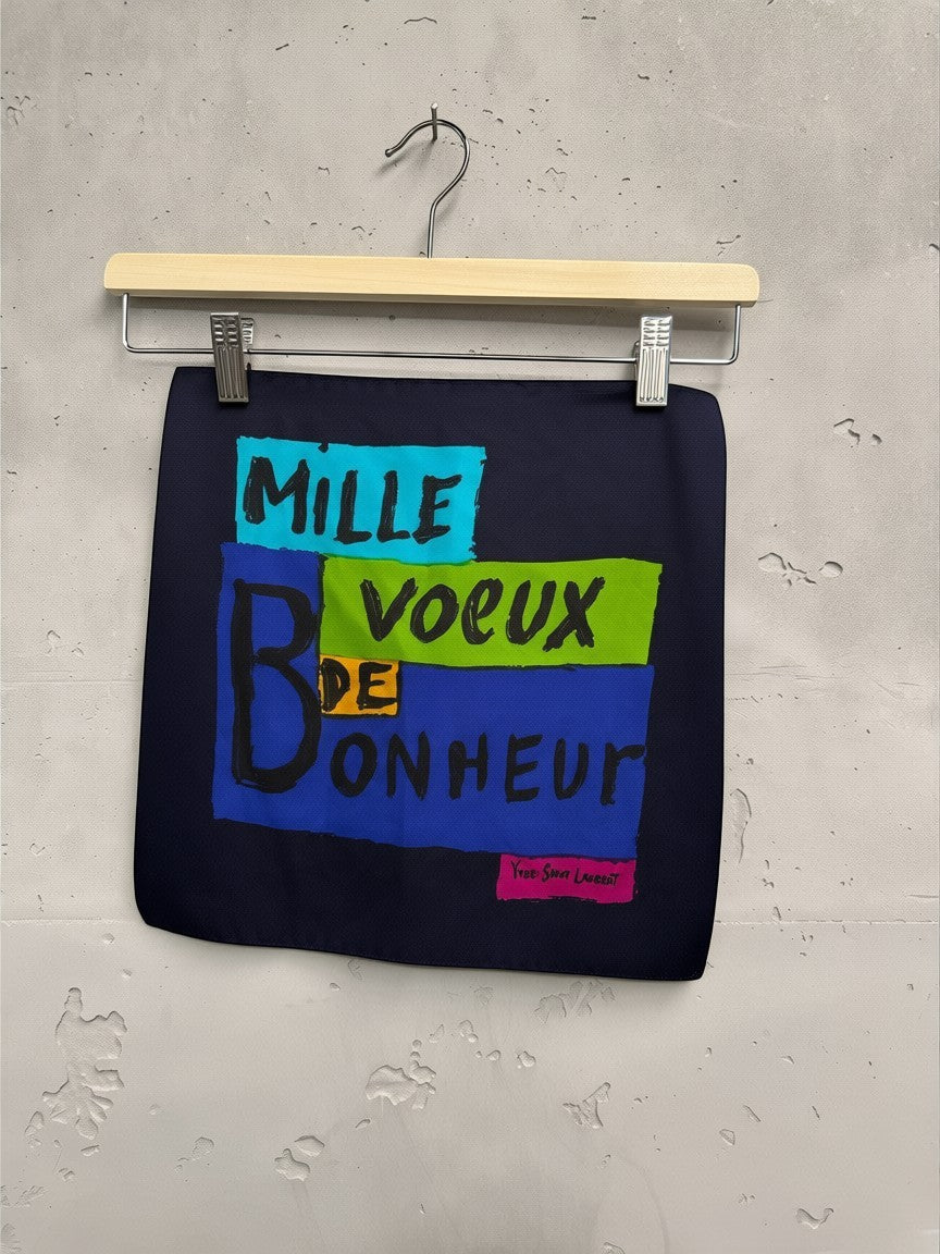 BERLIN VINTAGE CORNER Yves Saint Laurent navy blue silk scarf with graphic print and lettering in turquoise, lime green, yellow, and blue.