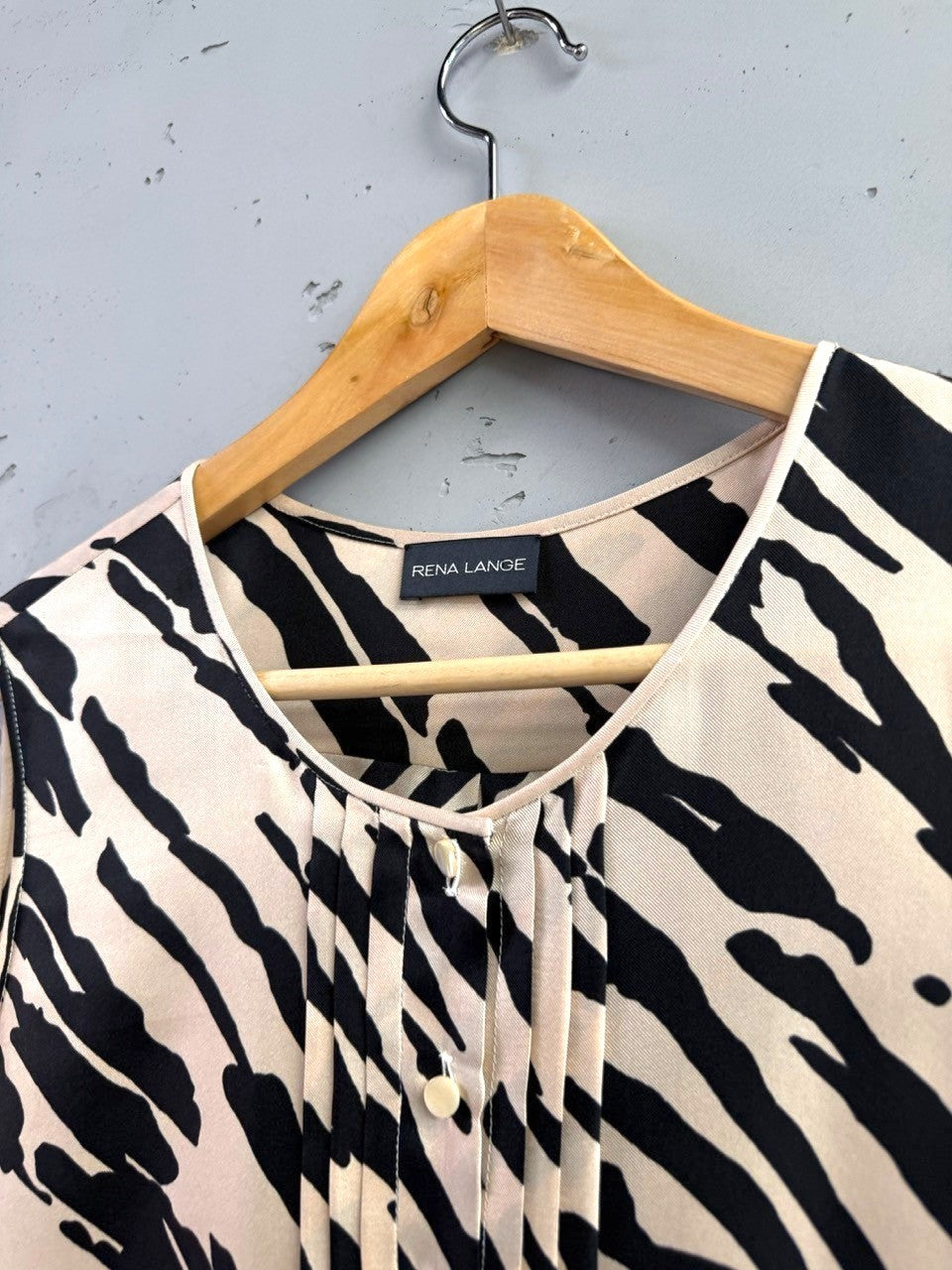 BERLIN VINTAGE CORNER black and sand zebra print silk blouse with V-neck and pleating detail.