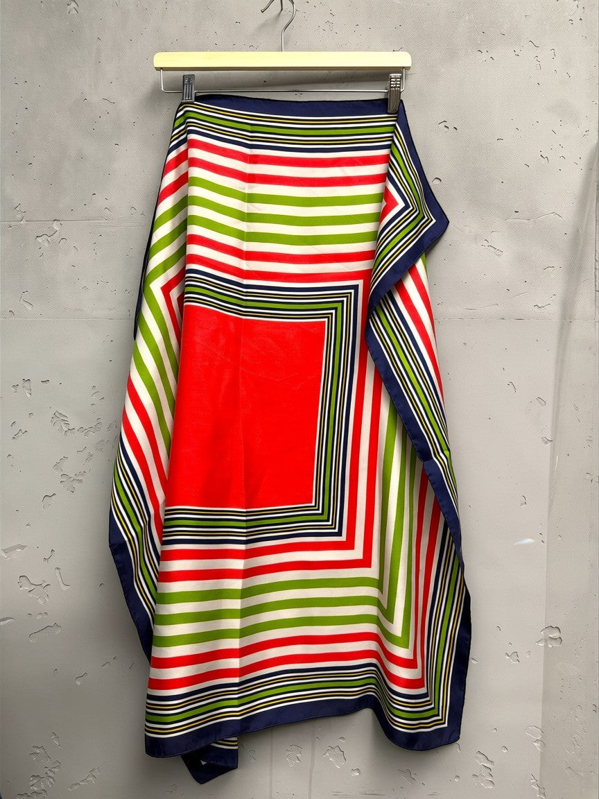 BERLIN VINTAGE CORNER Yves Saint Laurent red, green, white, navy striped silk scarf with central red square.