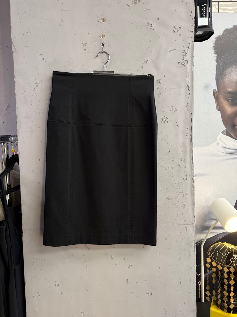 BERLIN VINTAGE CORNER MCM black pencil skirt, front view on a hanger